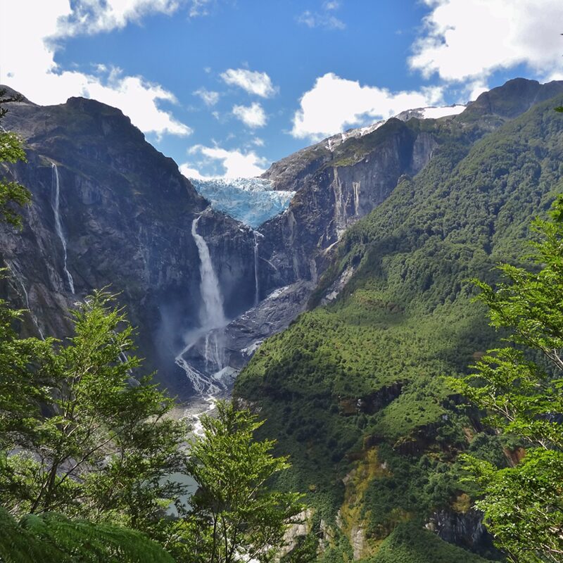Queulat National Park The stunning blue glacier and tall waterfall at Queulat National Park in Aysen, Patagonia