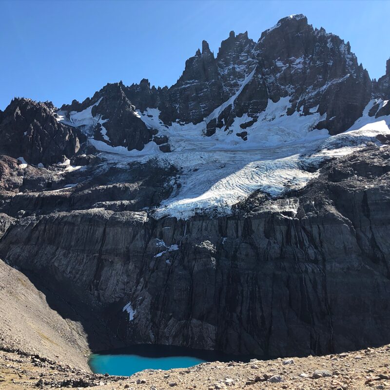 The stunning blue glacier and tall waterfall at Queulat National Park in Aysen, Patagonia