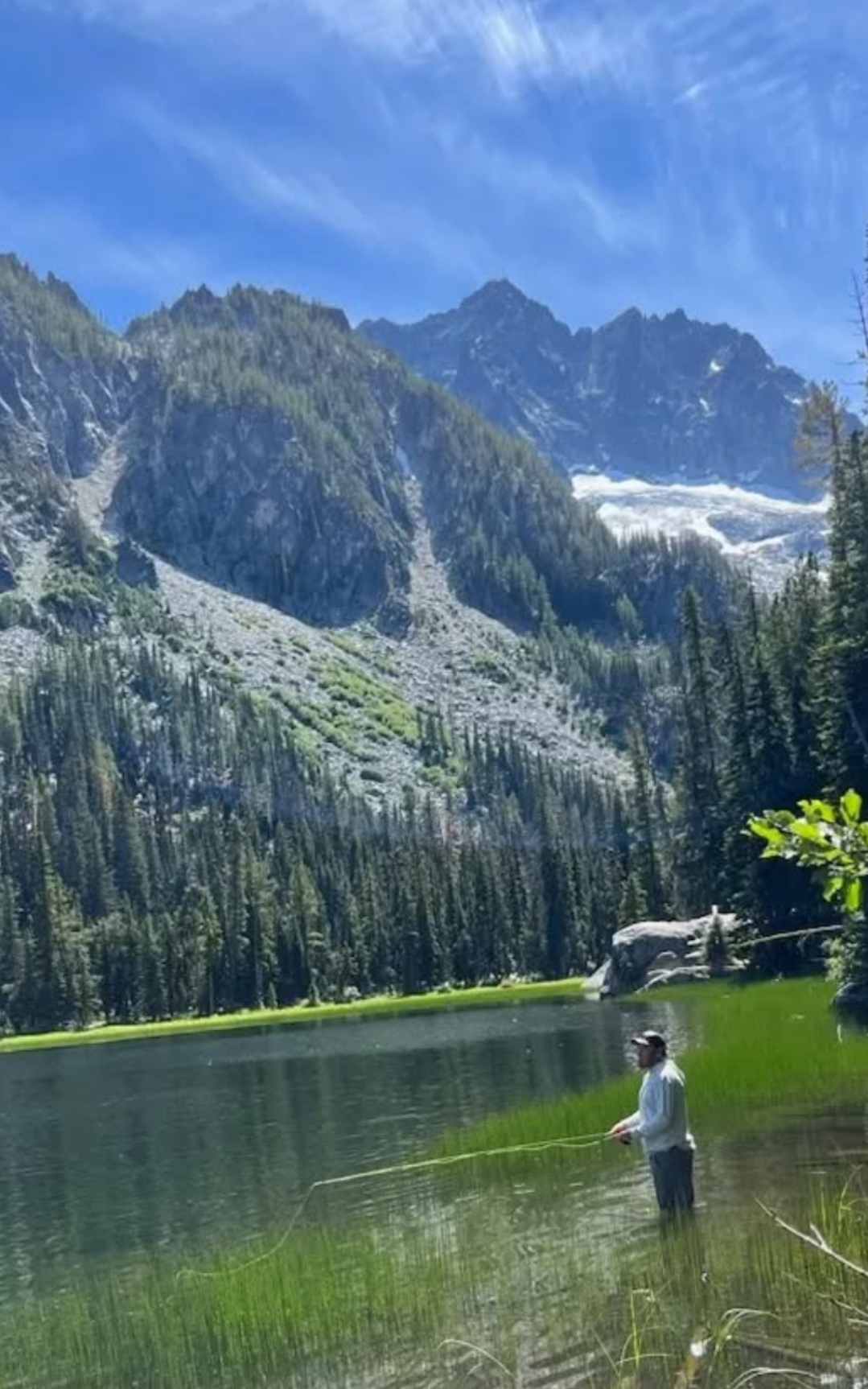David and Jorge fishing in the river, happy with fish in their hands.