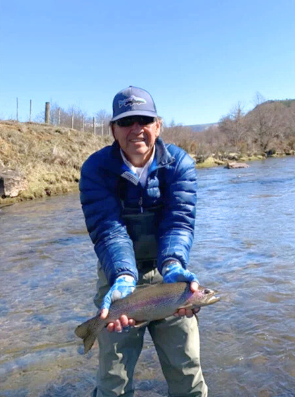 EKO PATAGONIA _ POSTS AGOSTO Jorge showing a fish he has just caught in the river.