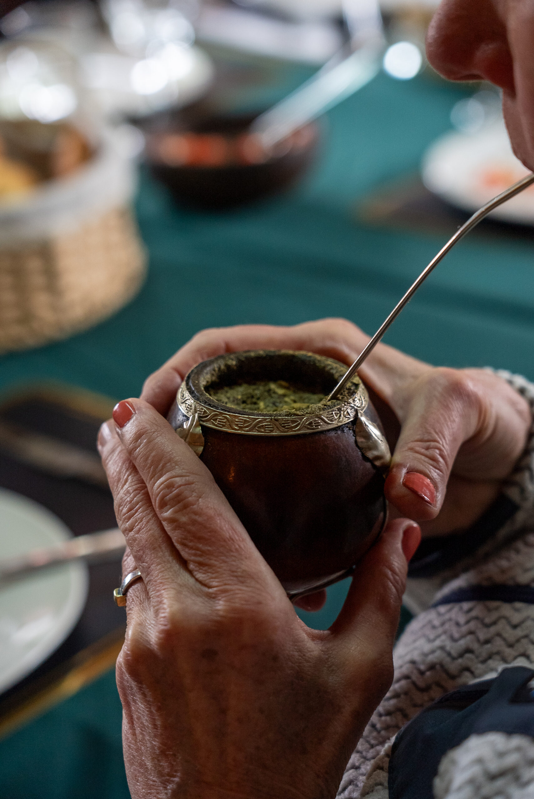 A rainbow arcs into a green valley; a wooden fence stands in the foreground